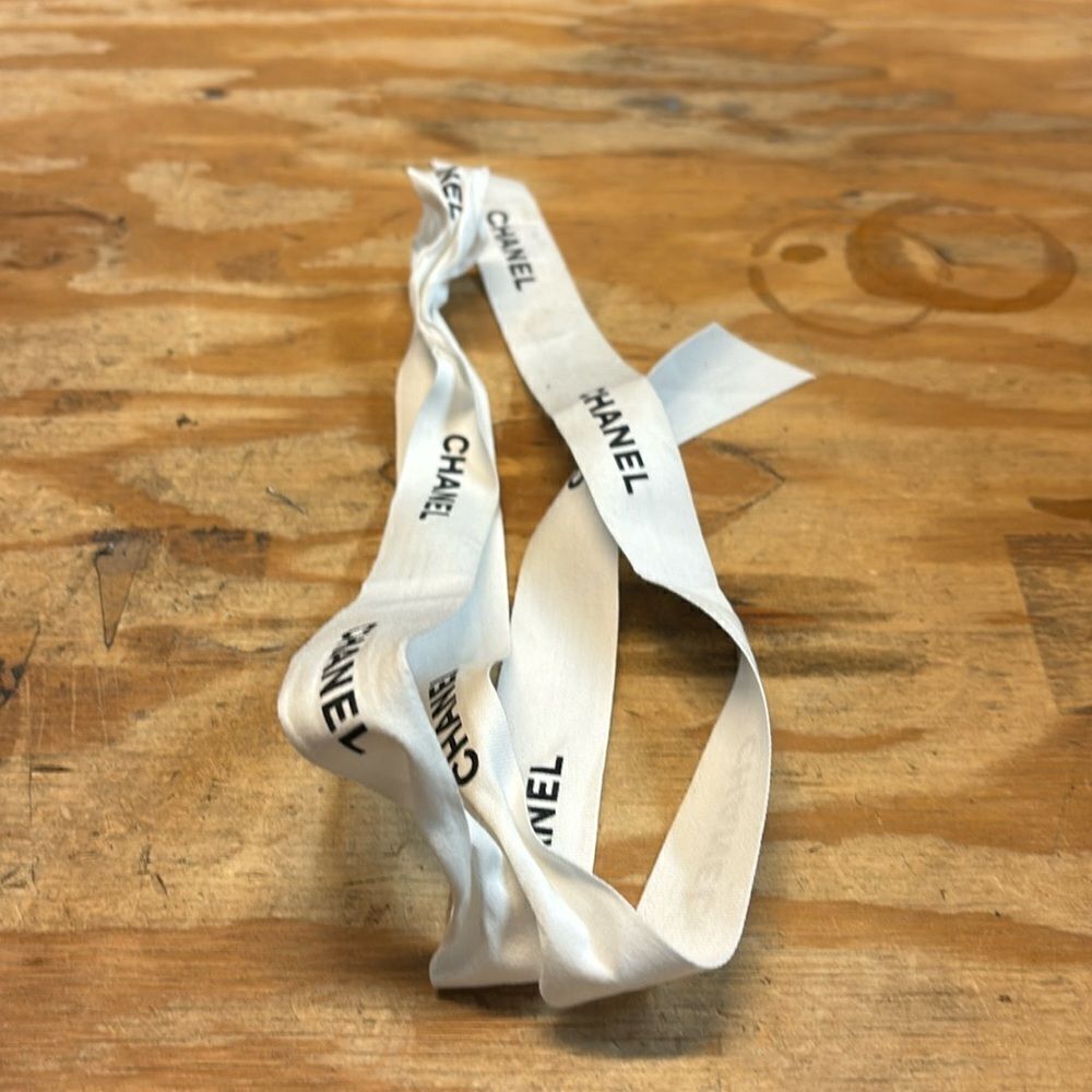 Chanel white ribbon with black writing of Chanel